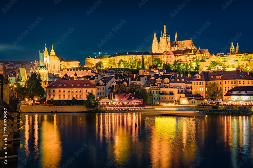 Spectacular night view from Charles Bridge of Prague Castle and St. Vitus cathedral on Vltava river. Illuminated spring cityscape of Prague, Czech Republic, Europe. Traveling concept background..