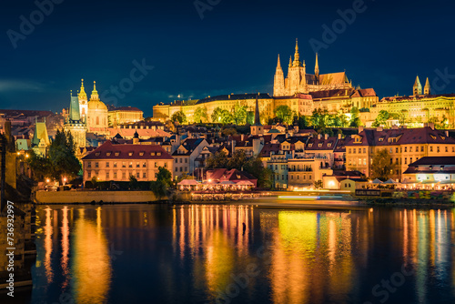 Spectacular night view from Charles Bridge of Prague Castle and St. Vitus cathedral on Vltava river. Illuminated spring cityscape of Prague  Czech Republic  Europe. Traveling concept background..