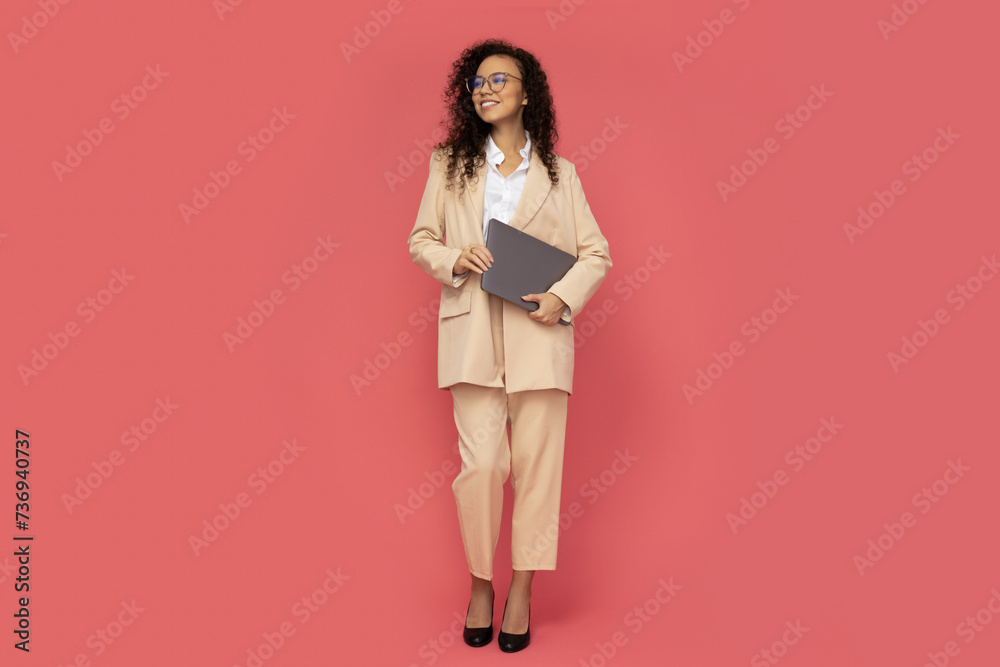 Attractive businesswoman in a suit with a laptop Attractive businesswoman in a suit with a laptop