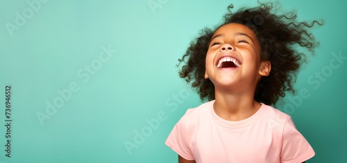 Joyful Pacific Islander girl radiating playfulness against a soothing pastel background with copy space