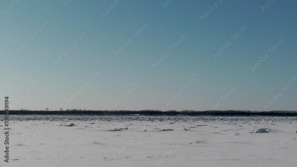 frozen and snow-covered river in sunny weather in winter frozen and snow-covered river in sunny weather in winter