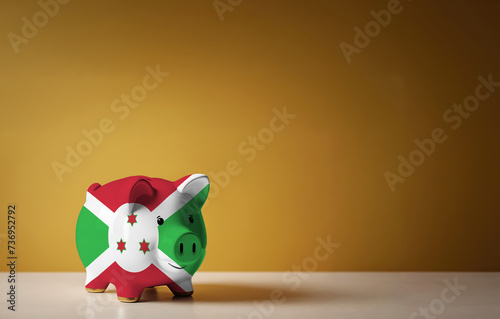 Piggy bank with painting of Burundi flag. The problem is in the economy. Economic crisis. Saving money concept.