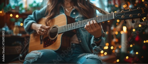 Happy young Woman hands playing acoustic guitar
