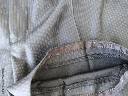 Obraz na plátne Stitch on the fabric with a sewing machine. Hemmed trousers