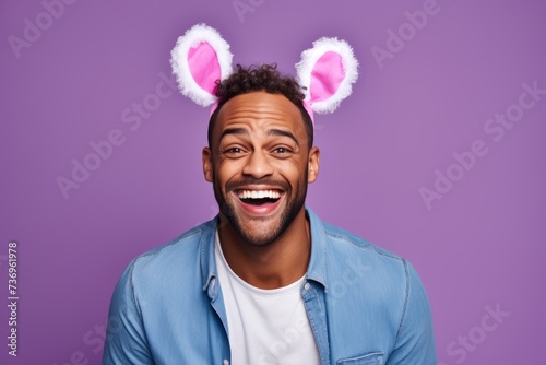  Photography a person of mixed race, aged 30, with bunny ears and a bright smile, set against a light pastel violet backdrop, offering ample space for Easter greetings or promotional text