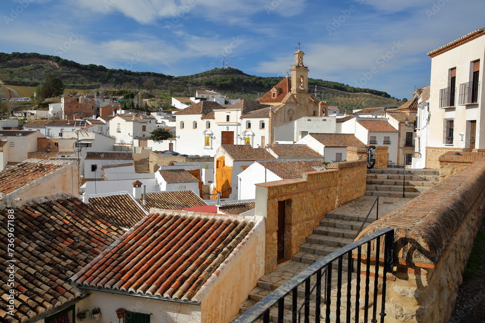 Santa Maria de Jesus church, located on Portichuelo square in Antequera, Malaga province, Andalusia, Spain, with whitewashed houses and typical roofs