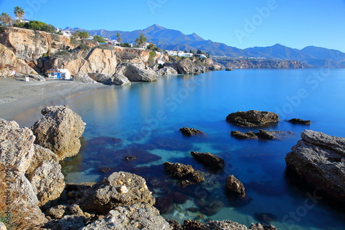 Playa Calahonda (Calahonda beach) and the rocky coast of the village Nerja, Axarquia, Malaga province, Andalusia, Spain, with the mountains in the background photo