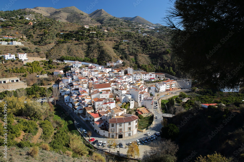 Obraz premium Aerial view of the village of Archez, Axarquia, Malaga province, Andalusia, Spain, with whitewashed houses and surrounded by mountains and trees