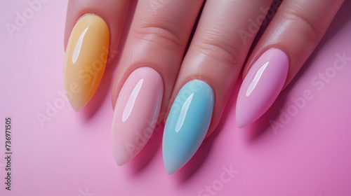 Trendy Skittle Nails Manicure on Pink Surface  Fashionable Pastel Colored Nail Polish  Meticulous Grooming Style  Playful Nail Artistry  Oval Tipped and Neatly Applied by Hands Resting on Surface