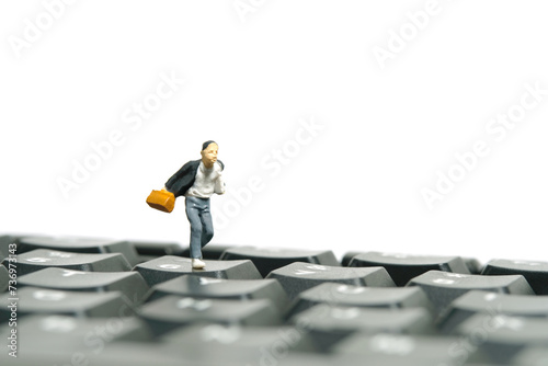 Miniature people toy figure photography. A boy pupil student running above keyboard. Isolated on a white background
