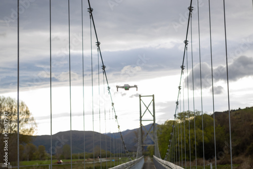 drone flying over mataura river bridge in new zealand