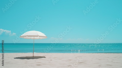 A solitary white beach umbrella offers a peaceful and minimalist scene on a pristine beach, perfect for relaxation and vacation themes with a vast, clear sky and tranquil sea.