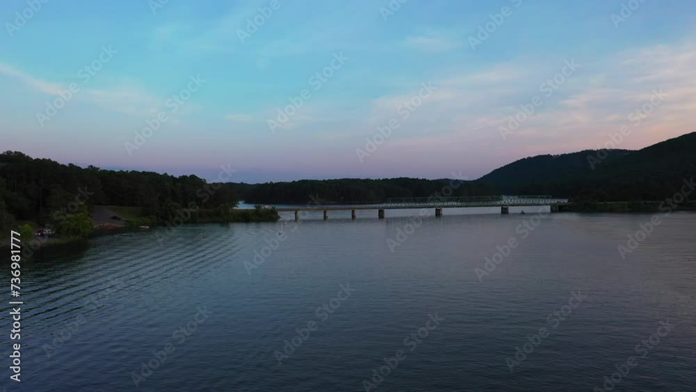 Forwards fly above water surface, heading towards road bridge over Lake Allatoona. Atlanta, Georgia, USA Forwards fly above water surface, heading towards road bridge over Lake Allatoona. Atlanta, Georgia, USA
