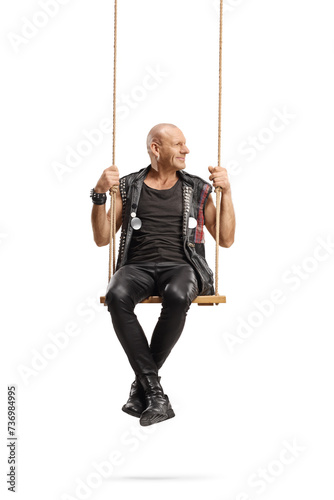 Punk sitting on a swing and looking to the side
