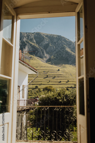 Iconic view from balcony over the Piatra Secuiului Cliff. Charming view over the meadow from a window.