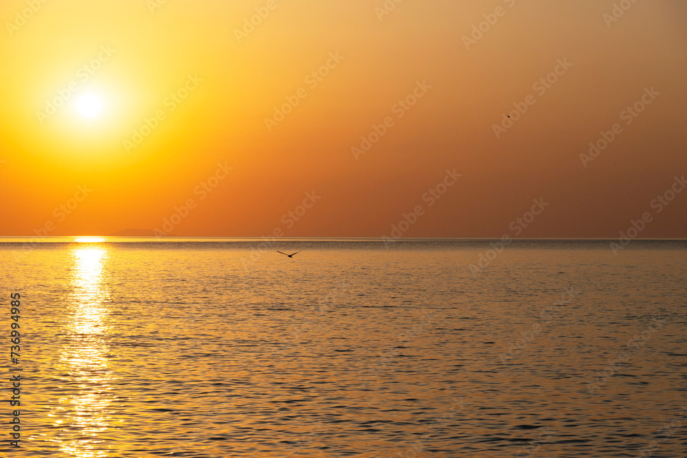 Beautiful sunrise over the sea. Natural orange background. Seascape. Copy space.