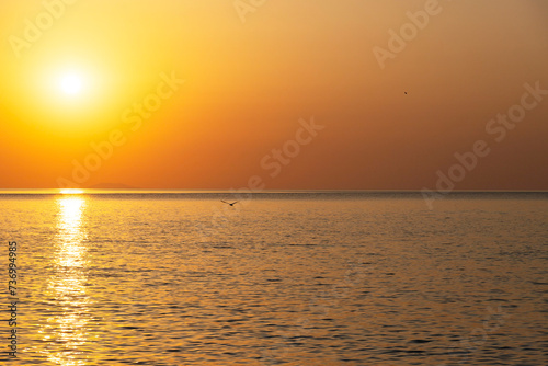 Beautiful sunrise over the sea. Natural orange background. Seascape. Copy space.