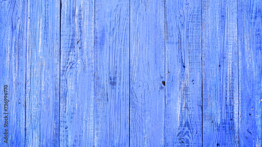 An old wooden background, painted bright blue. Wooden surface with cracks. An old wooden background, painted bright blue. Wooden surface with cracks.