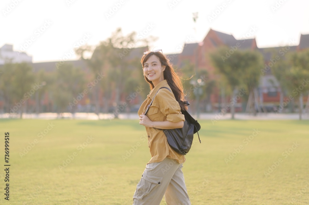 Traveler asian woman in her 30s stands bathed in the golden glow of sunset, embracing the freedom of exploration. on summer holiday weekend vacation trip in Bangkok, Thailand Traveler asian woman in her 30s stands bathed in the golden glow of sunset, embracing the freedom of exploration. on summer holiday weekend vacation trip in Bangkok, Thailand