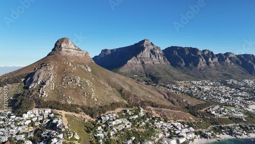 Drone shot showing Lions Head Mountain and Table Mountain that reveals Cape Town, South Africa and the Ocean 