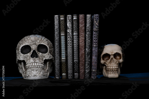 Antique embossed books with sculptured skull book ends with Smokey and spooky background Handmade