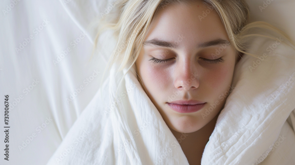 A serene young blonde woman wrapped in white sheets, her eyes closed, evoking a sense of pure relaxation and comfort A serene young blonde woman wrapped in white sheets, her eyes closed, evoking a sense of pure relaxation and comfort