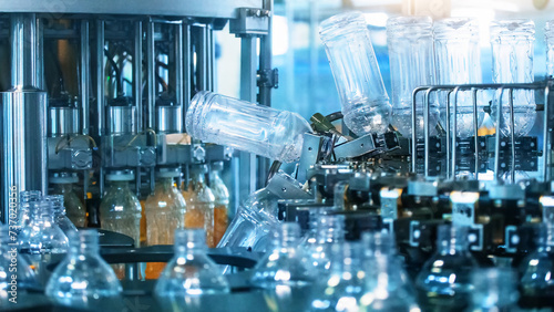 Fényképezés Process of filling plastic bottles inside industrial machine conveyor line in wa