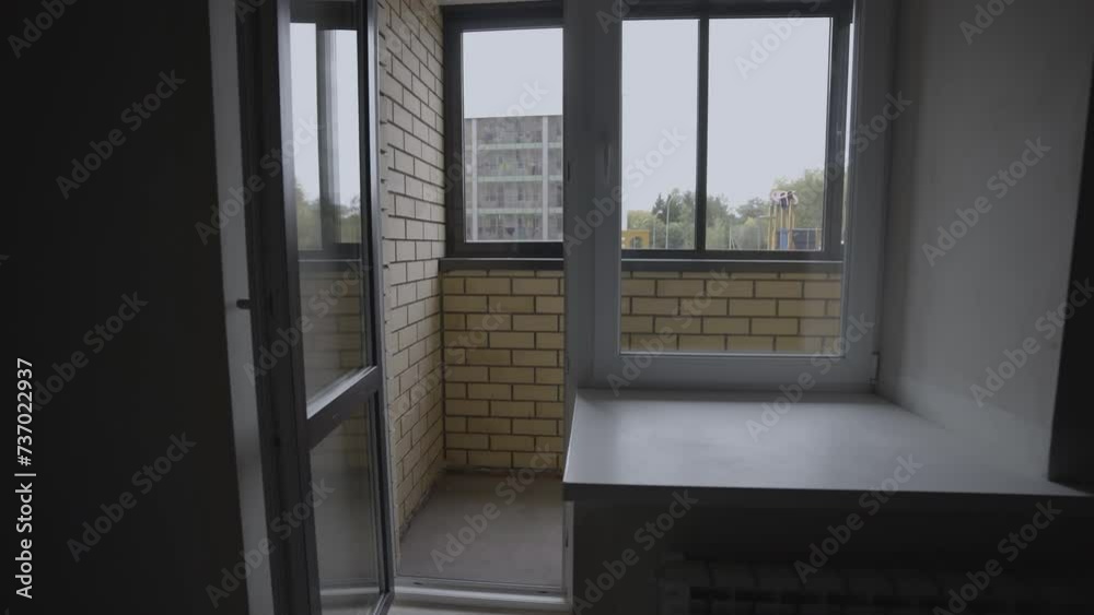 Balcony adorned with brick trim in room without renovation. Apartment for personalized design interventions in modern residential building