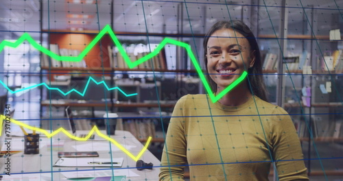 Image of data processing over biracial businesswoman smiling in office