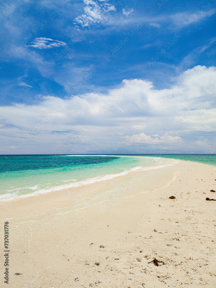 Ocean waves on shoreline. Sandbank in Camiguin Island. Philippines.