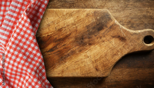 Old wooden cutting board with a red and white checkered tablecloth on a wooden table with copy space. Template for recipes or food and drink menu. Generative Ai. photo