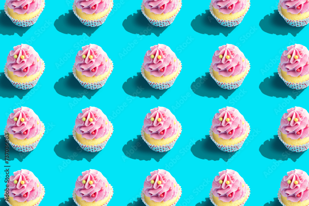 Colorful cupcake pattern on pastel blue background. Creative minimal party concept. Colorful cupcake pattern on pastel blue background. Creative minimal party concept.