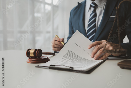 Lawyer is signing contract in the office, Diligent lawyer at work in a law firm, signing official document, Judge gavel with Justice lawyers, lawyer working on a documents, advice and justice concept.