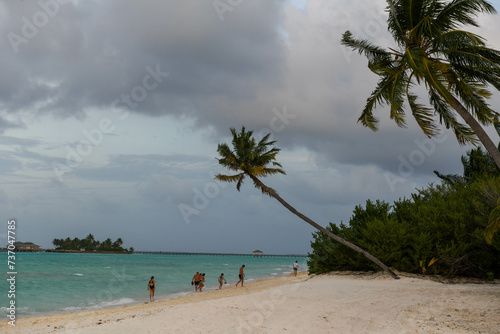People on the beach of Villa Park resort on Ari atoll in Maldives