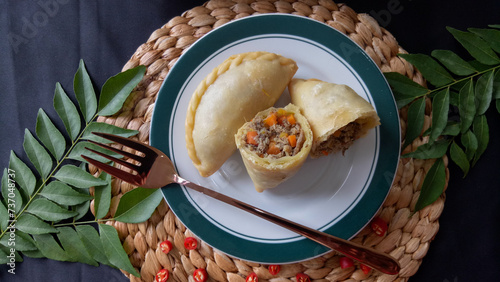 Empanada or Panada, Indonesian traditional snack from Manado, North Sulawesi. Enriched with filled with shredded smoke skipjack tuna fish at the inside. Selective focus.
 photo