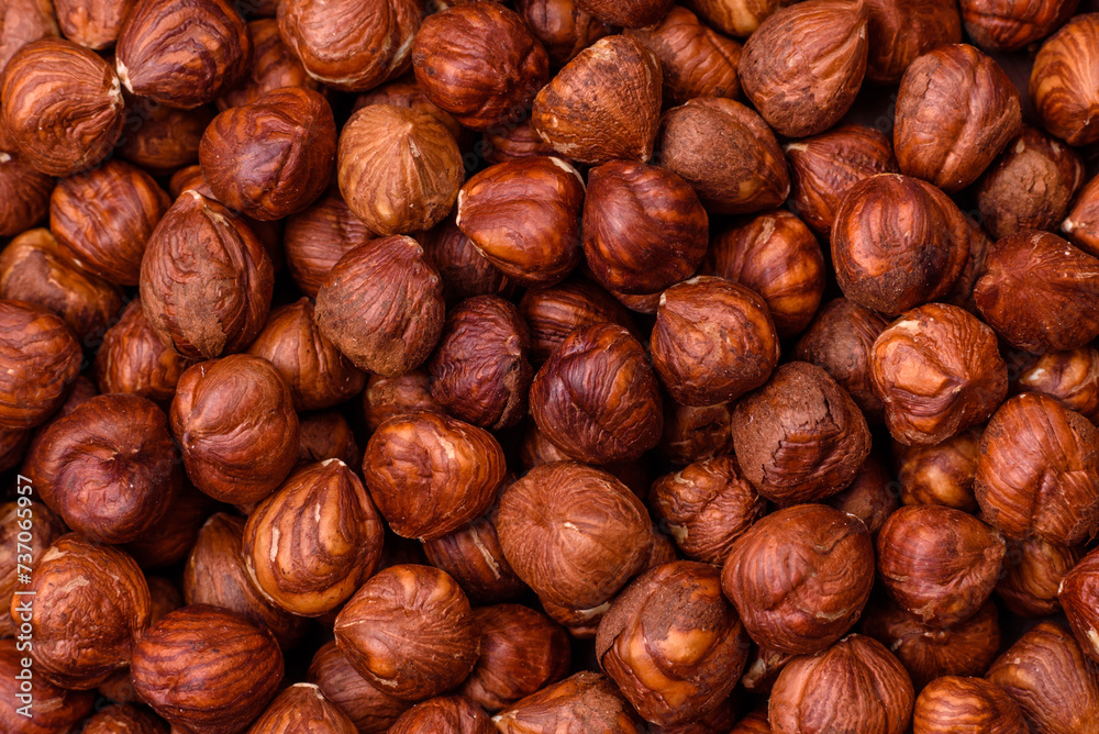 Delicious hazelnut whole, raw, without shell, on a dark concrete background Delicious hazelnut whole, raw, without shell, on a dark concrete background