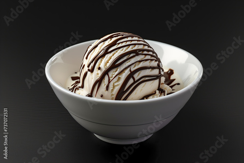 vanilla ice cream with chocolate drizzle in a white bowl isolated on black background