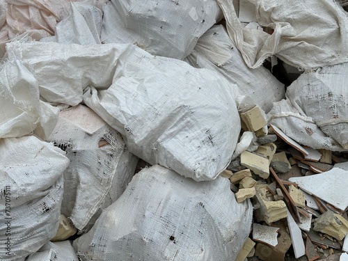 A pile of white bags with construction waste