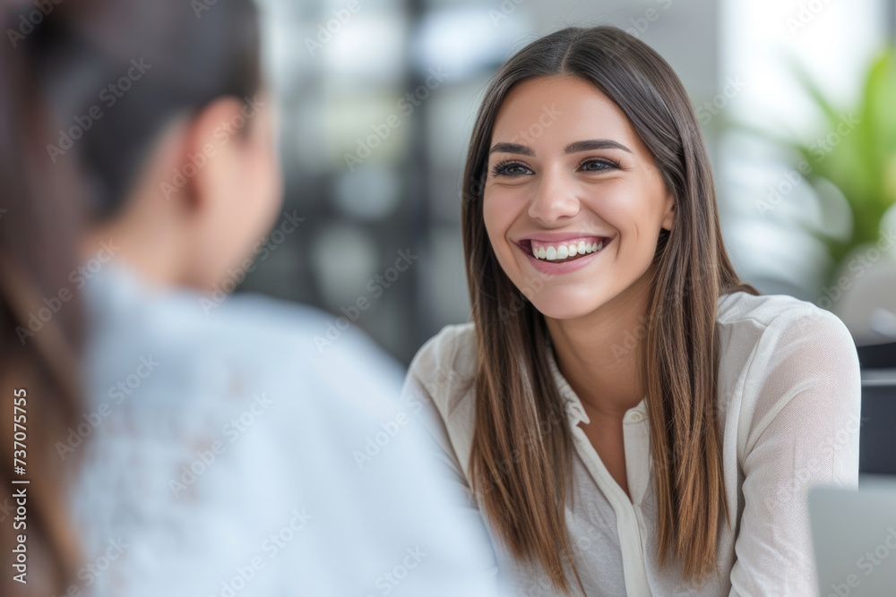 Young woman doing a job interview. Business colleagues having a conversation. Smiling businesswoman taking interview of a job applicant. Friendly recruitment manager interviewing young women in office - obrazy, fototapety, plakaty 