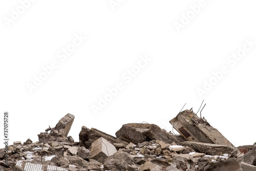 A pile of large gray concrete debris with protruding fittings and the remnants of snow isolated on a white background. Remnants of the destruction of a large concrete building. Background