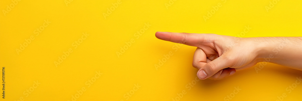 © daniel - Hand finger pointing isolated on yellow background © daniel - Hand finger pointing isolated on yellow background