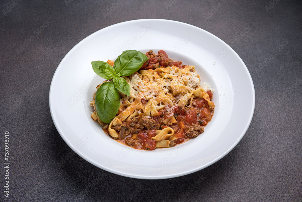 Pasta with bolognese sauce, parmesan and basil