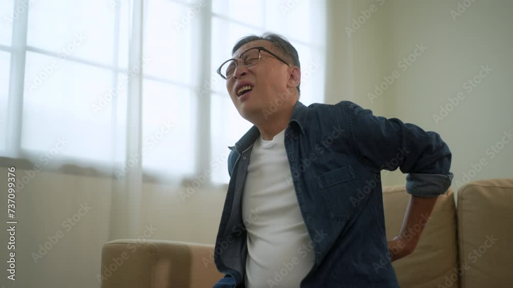 Asian senior man suffering from back pain, backache syndrome in old man, health problem and chronic disease, lumbar pain symptom in retirement, expression painful with physical low back pain Asian senior man suffering from back pain, backache syndrome in old man, health problem and chronic disease, lumbar pain symptom in retirement, expression painful with physical low back pain