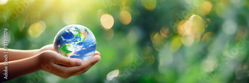 International human solidarity day concept. Children hands holding earth globe over blurred abstract green nature background. saving planet, environment ecology concepts.Banner,advertisement. #737105176