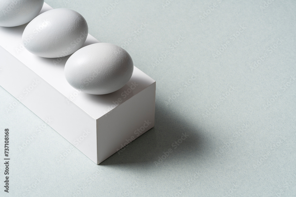 White ggs in a row on gray background with copy space White ggs in a row on gray background with copy space