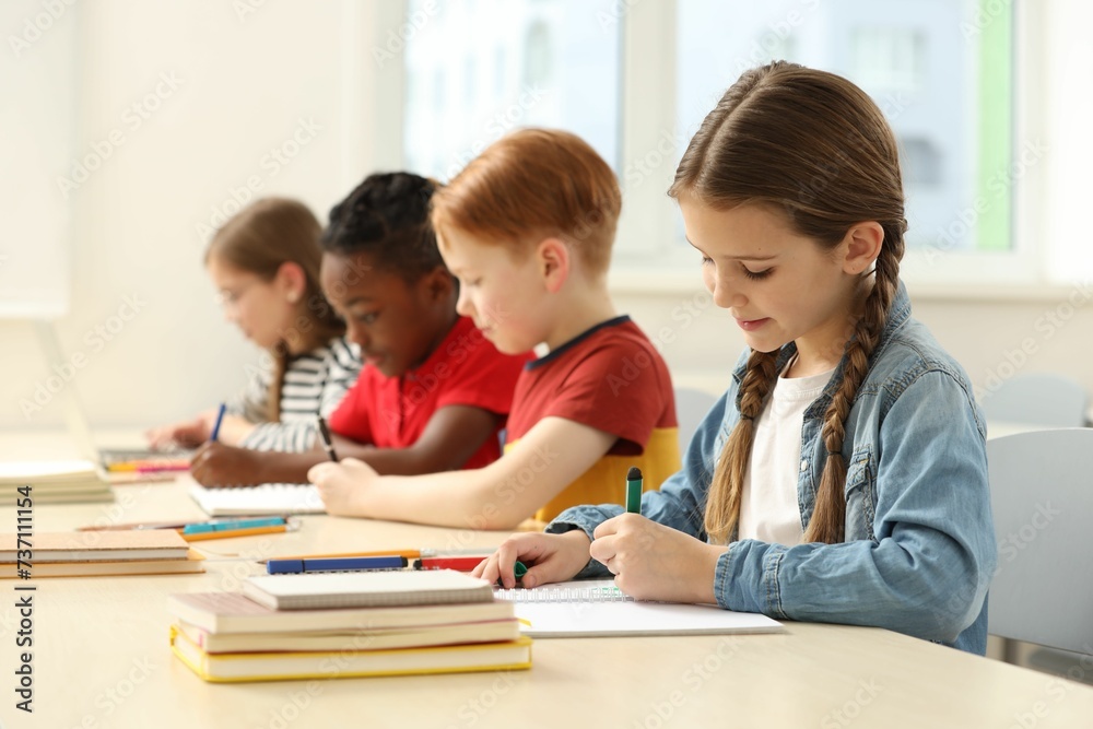 Cute children studying in classroom at school Cute children studying in classroom at school