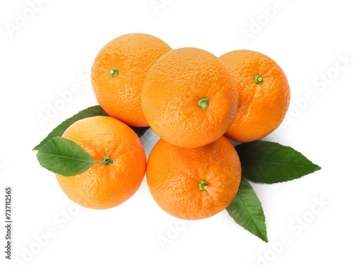 Fresh ripe oranges with green leaves on white background  top view