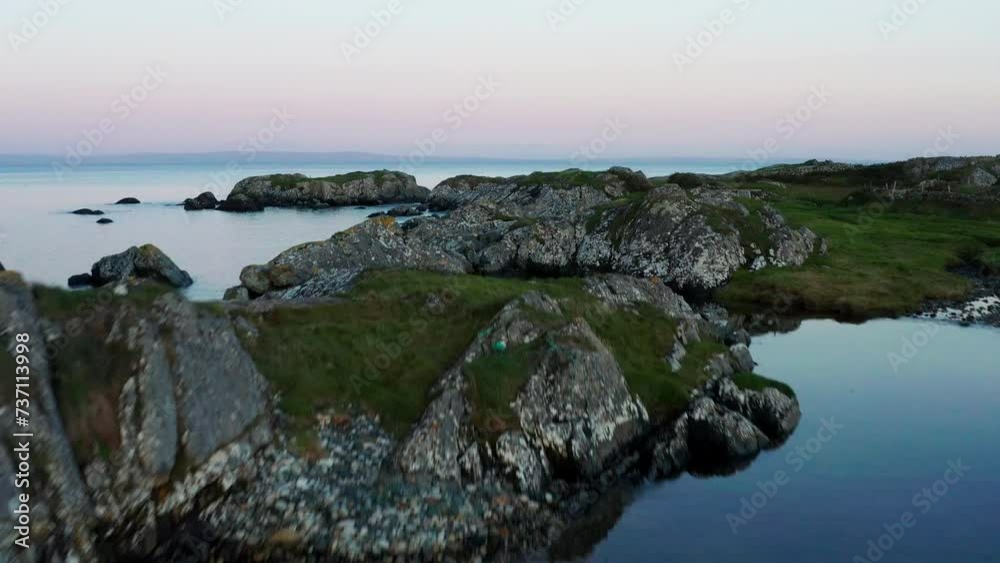 Experience Connemara's beauty with a mesmerizing drone shot capturing lush green landscapes along the coast, accompanied by graceful seagulls and birds. Experience Connemara's beauty with a mesmerizing drone shot capturing lush green landscapes along the coast, accompanied by graceful seagulls and birds.
