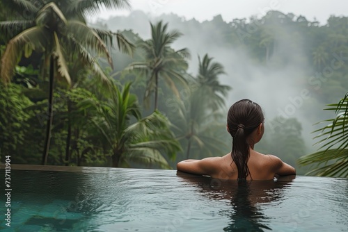 Mountain Oasis: Woman Relaxing in Resort Pool Surrounded by Tropical Scenery © Murda