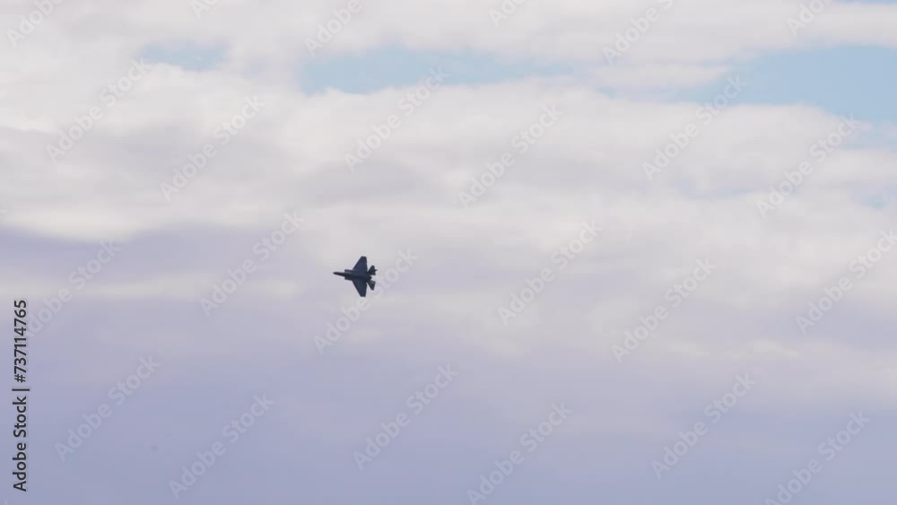 Panning Shot Of Aerobatic Fighter Plane Flying In Cloudy Sky On Sunny Day - Huntington Beach, California Panning Shot Of Aerobatic Fighter Plane Flying In Cloudy Sky On Sunny Day - Huntington Beach, California